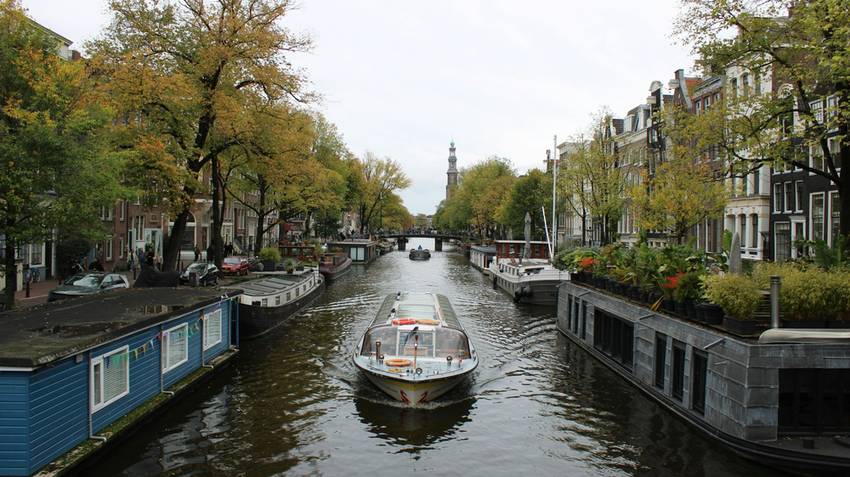 Amsterdam Canal Ring in the early morning with quiet bridges and canal reflections